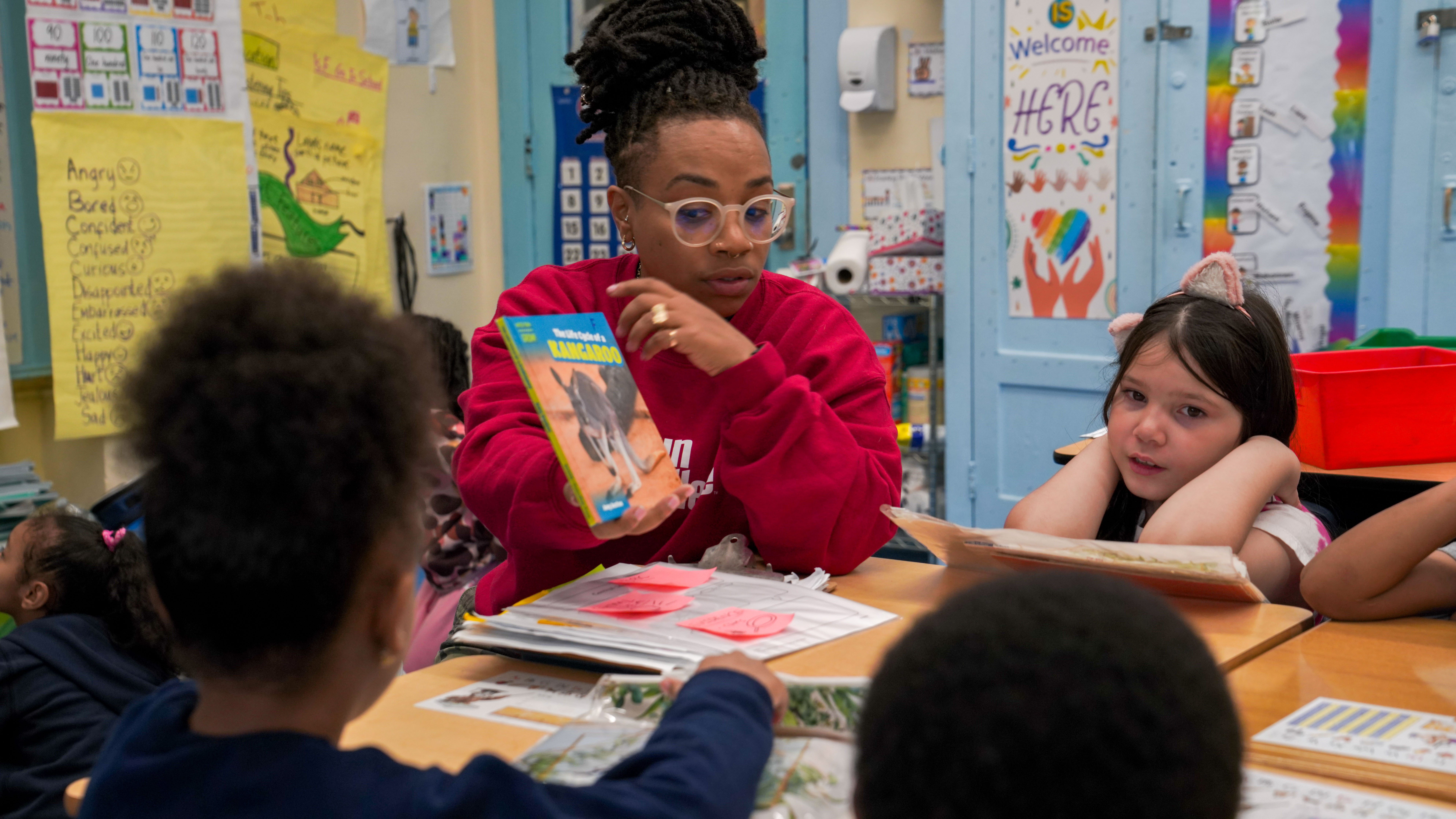 Teacher reading a kangaroo book aloud to young students
