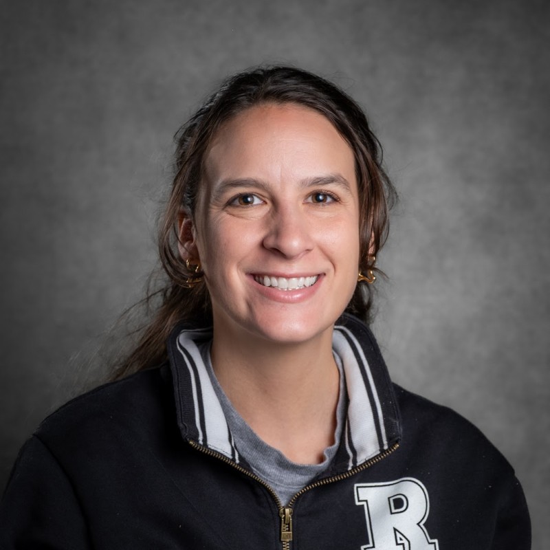 Ms. Katzenstein staff portrait wearing school letter jacket