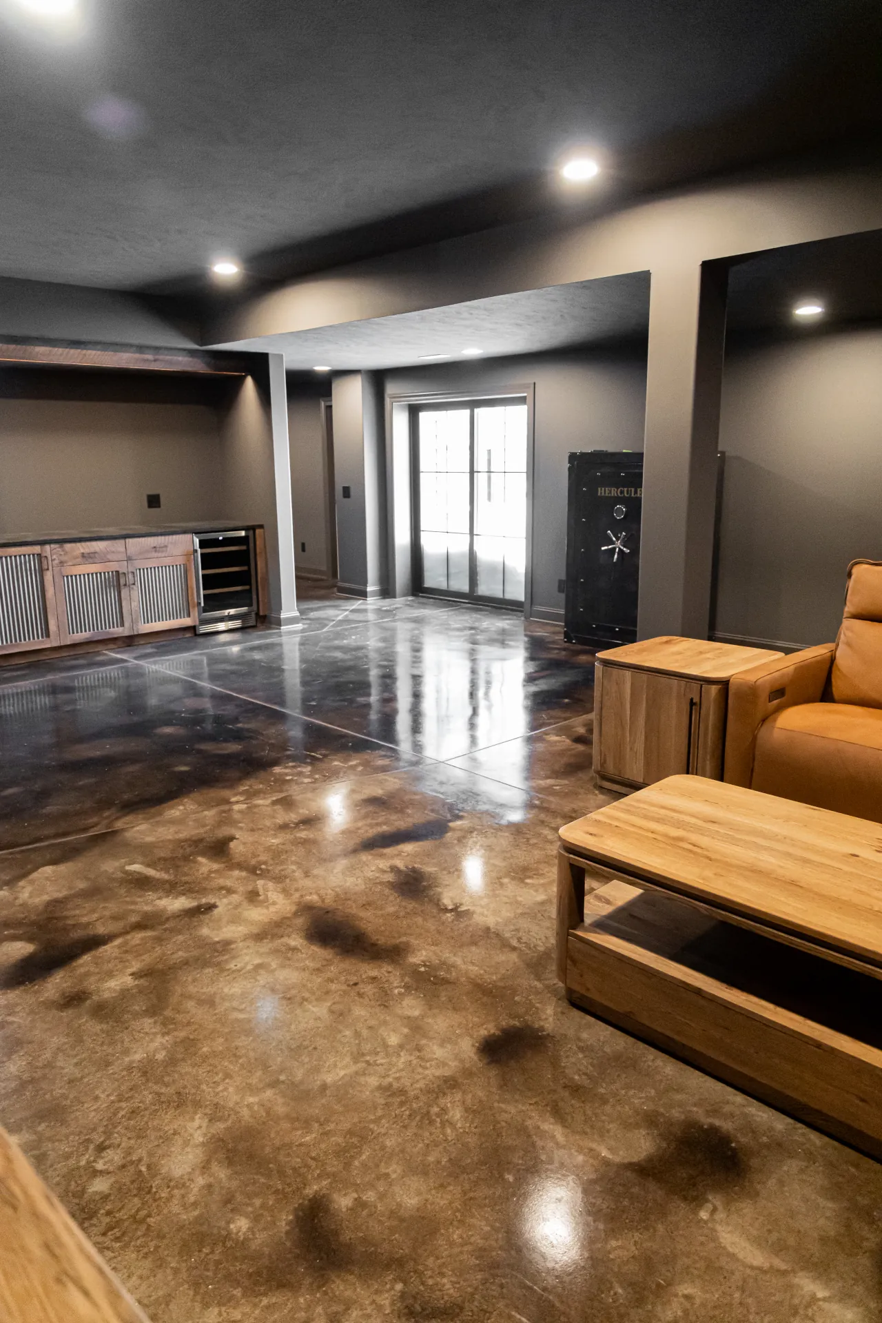 acid stained concrete flooring in a finished basement with reflective gloss finish, custom entertainment area, and contemporary design.