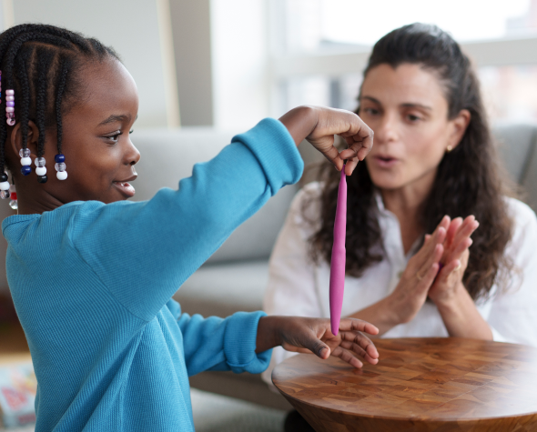 Therapist and child playing with play-doh