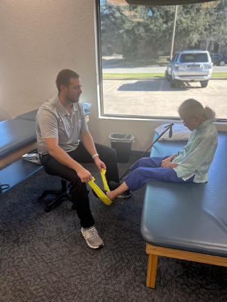 physical therapist conducting movement assessment with patient