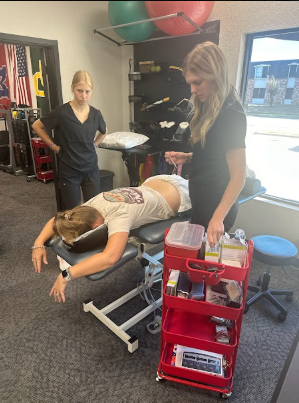  physical therapist performing a functional movement assessment with a patient