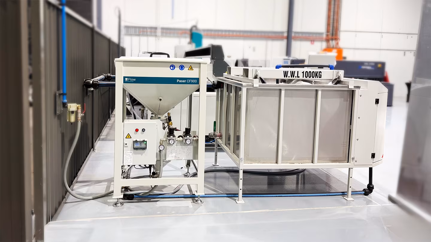Frontal view of a water jet cutting system abrasive management setup