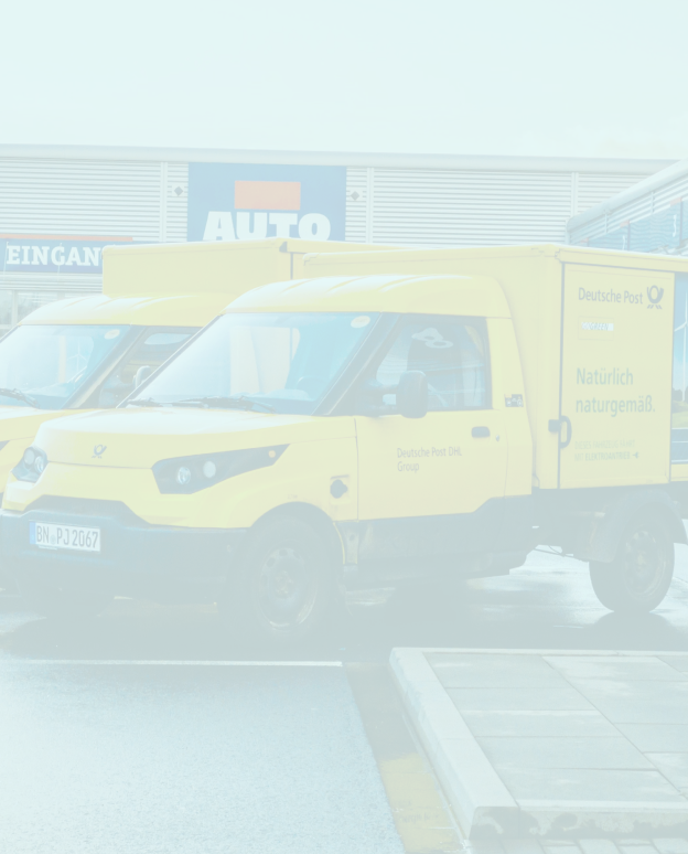 A couple of yellow trucks parked next to each other.