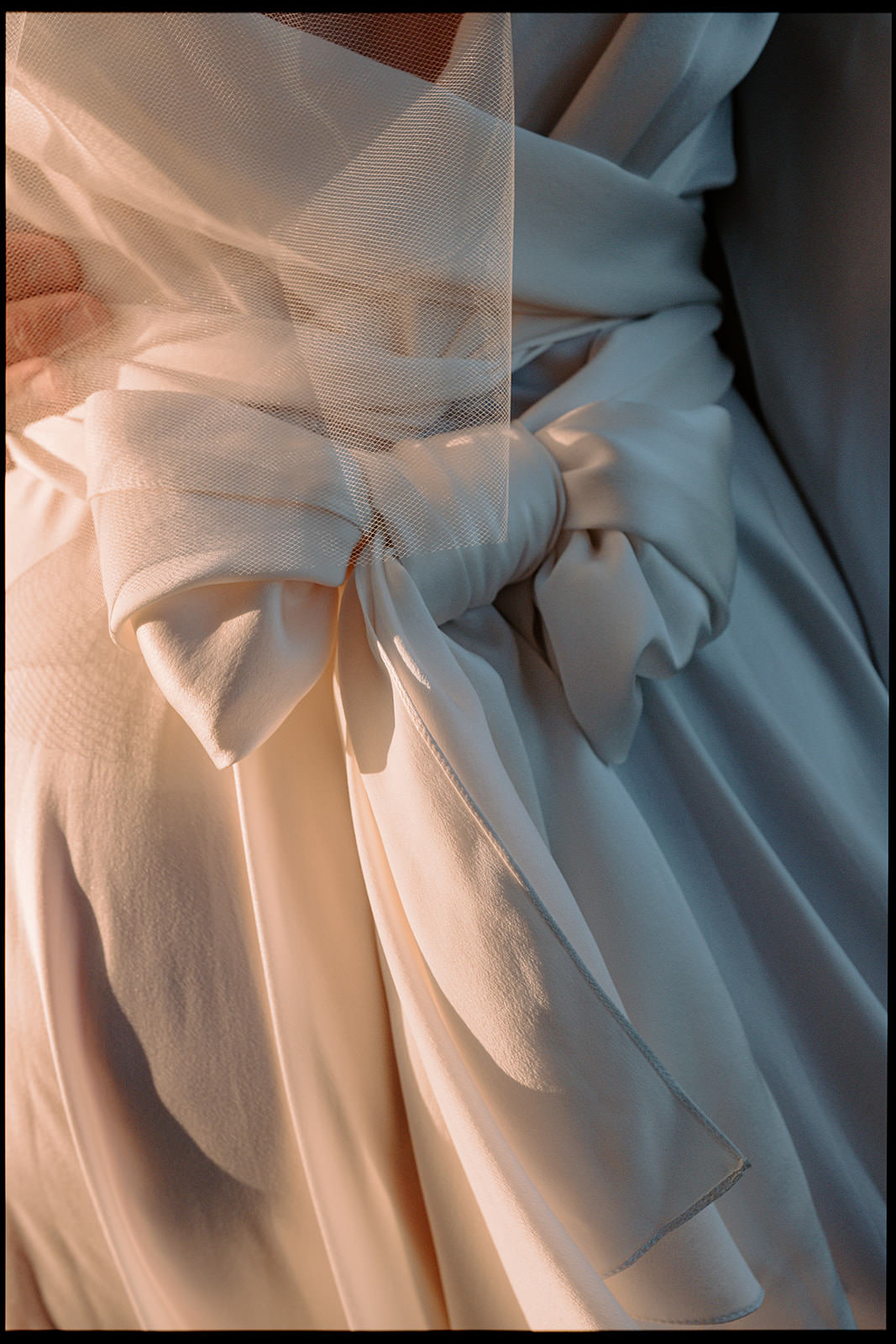 Detail of a bow on a pale pink wedding dress