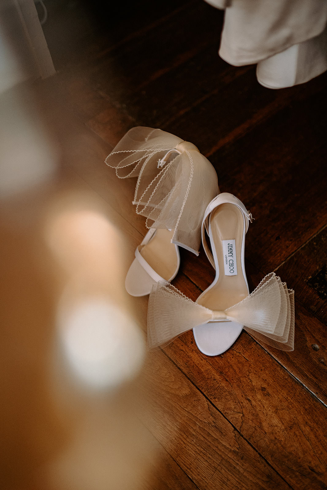 Bridal heels and veil on a wooden floor