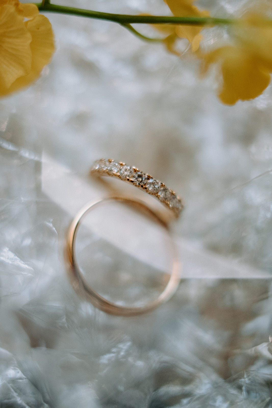 Gold wedding rings resting among flowers