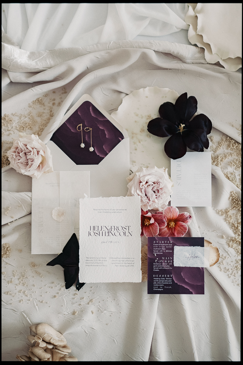 Wedding stationery flat lay with invitations, ribbons and flowers