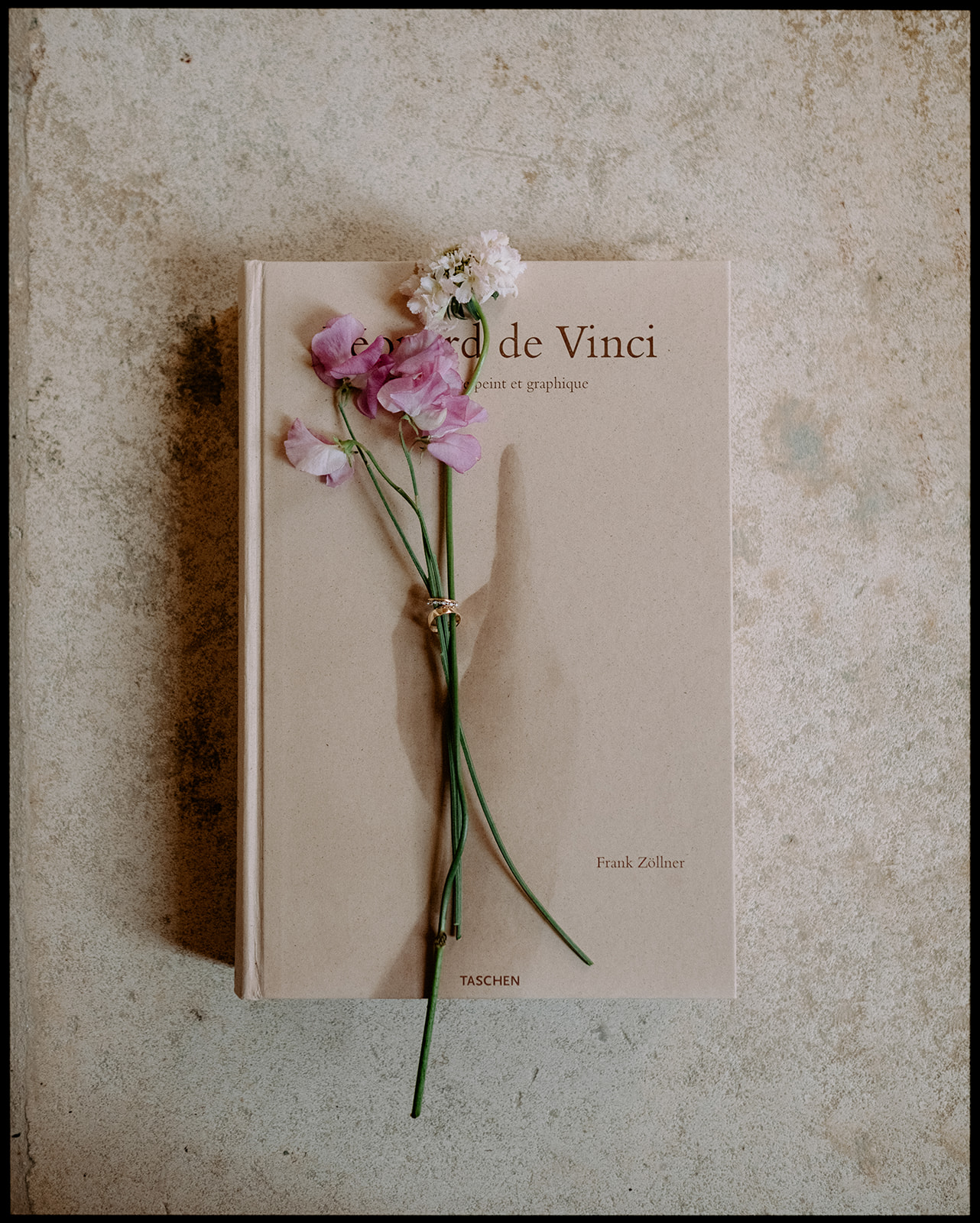 Flowers resting on a book about Leonardo da Vinci