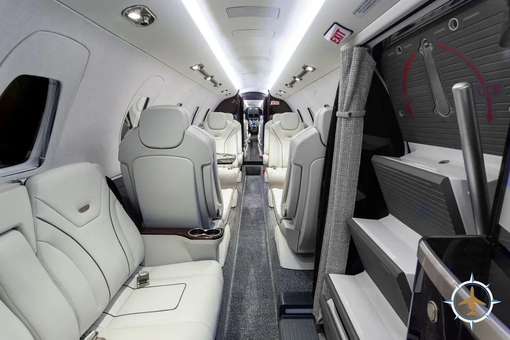 2024 Cessna Citation XLS Gen2 S/N 560-6360 - exterior of white and blue aircraft for sale, interior view of side facing seats looking backwards, Mikolay Jet group logo