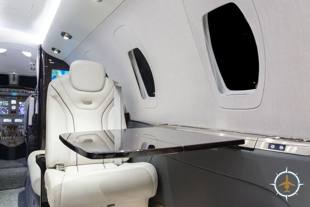 2024 Cessna Citation XLS Gen2 S/N 560-6360 - exterior of white and blue aircraft for sale, interior view of seat and foldout table, Mikolay Jet group logo
