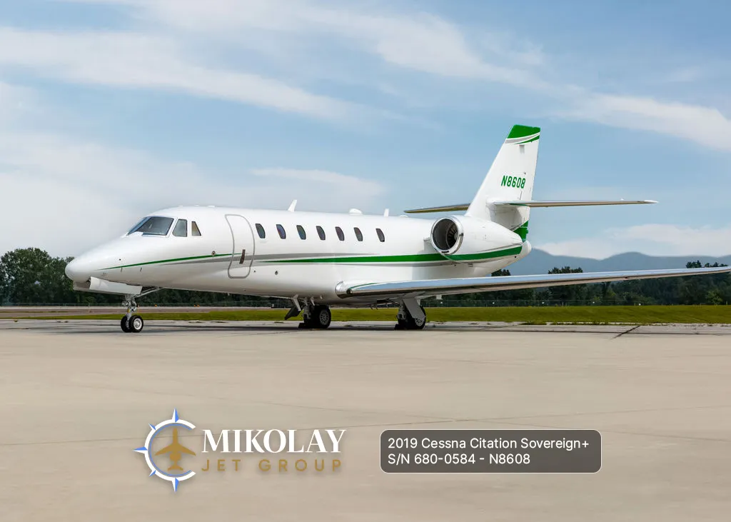 2019 Cessna Citation Sovereign+ S/N 680-0584 - exterior of white and green gray striped aircraft for sale, parked on tarmac during the daylight, Mikolay Jet group logo
