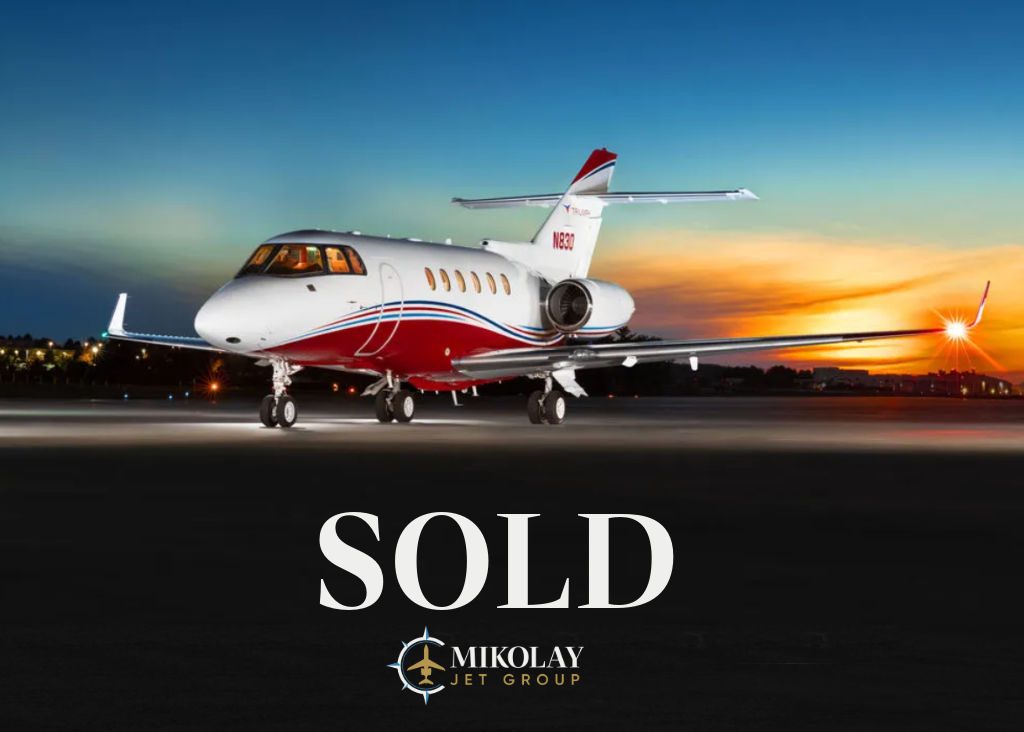 2006 Hawker 850XP S/N 258782 - exterior of white and burgundy aircraft for sale, parked in a hangar, Mikolay Jet group logo
