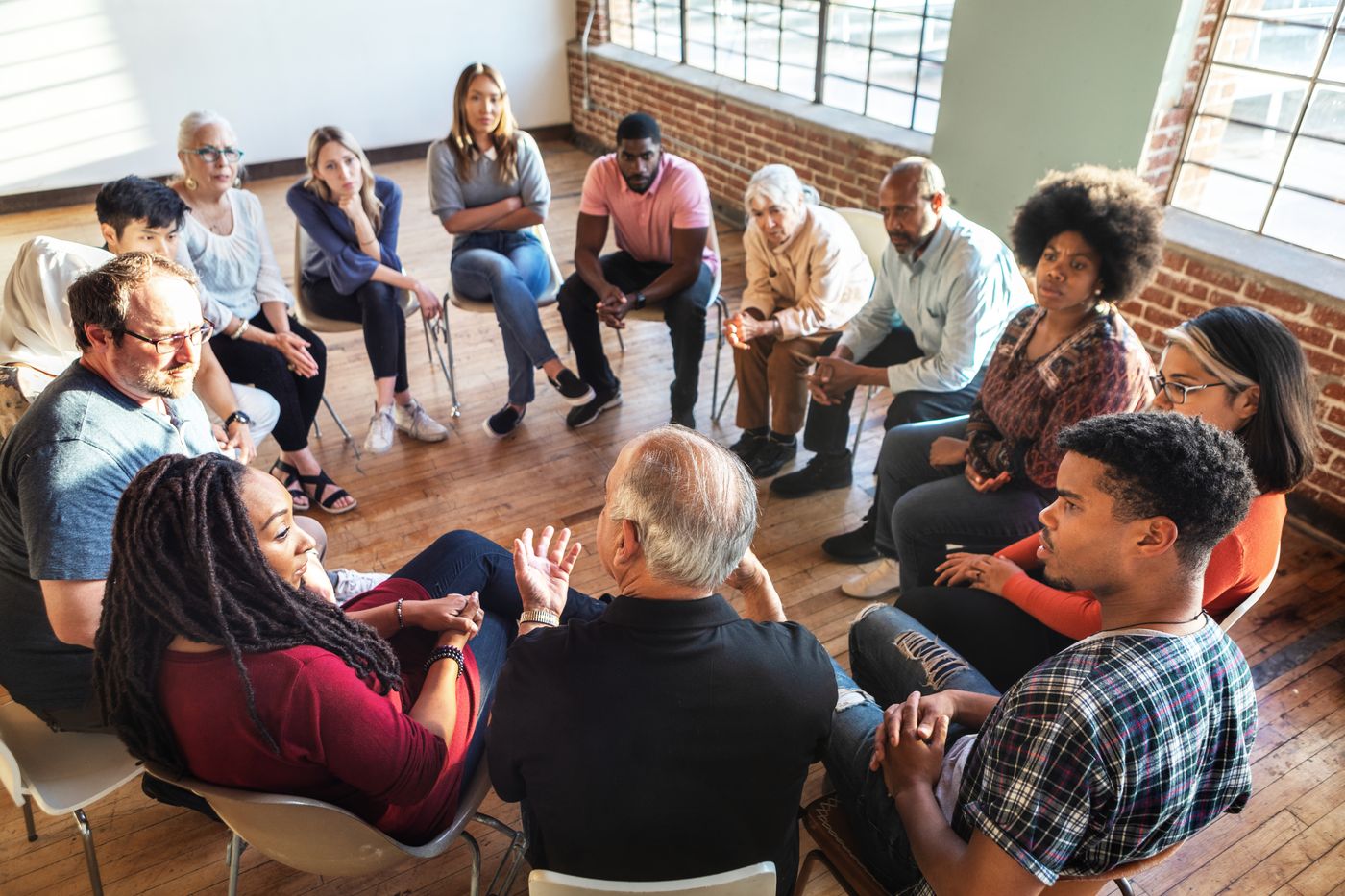 Group of adults seated in a circle during a support group session