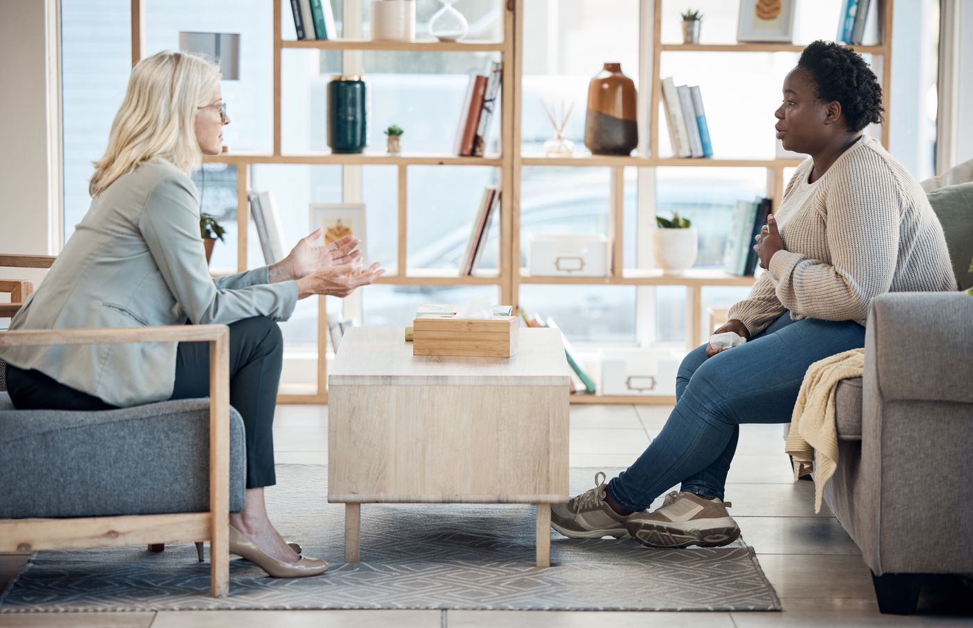 Counselor talking with a client in a bright therapy office