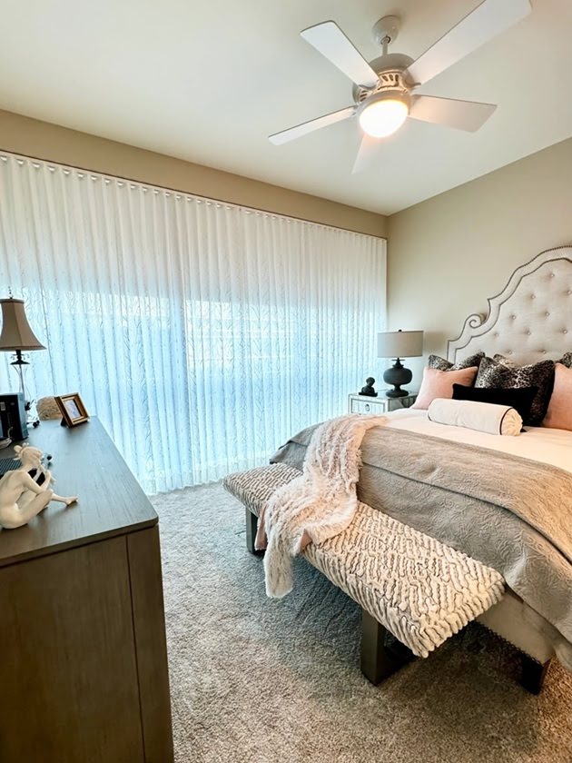 tall drapes overlaying window treatments for a large window 