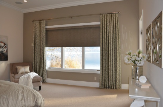 Bedroom featuring neutral window shades in Highland Park, TX, paired with elegant drapery for soft light control and privacy. These layered window shades create a calm and relaxing living environment.