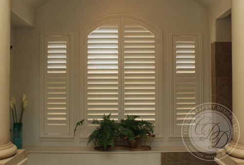 Custom arched window shutters in Highland Park, TX providing energy efficiency