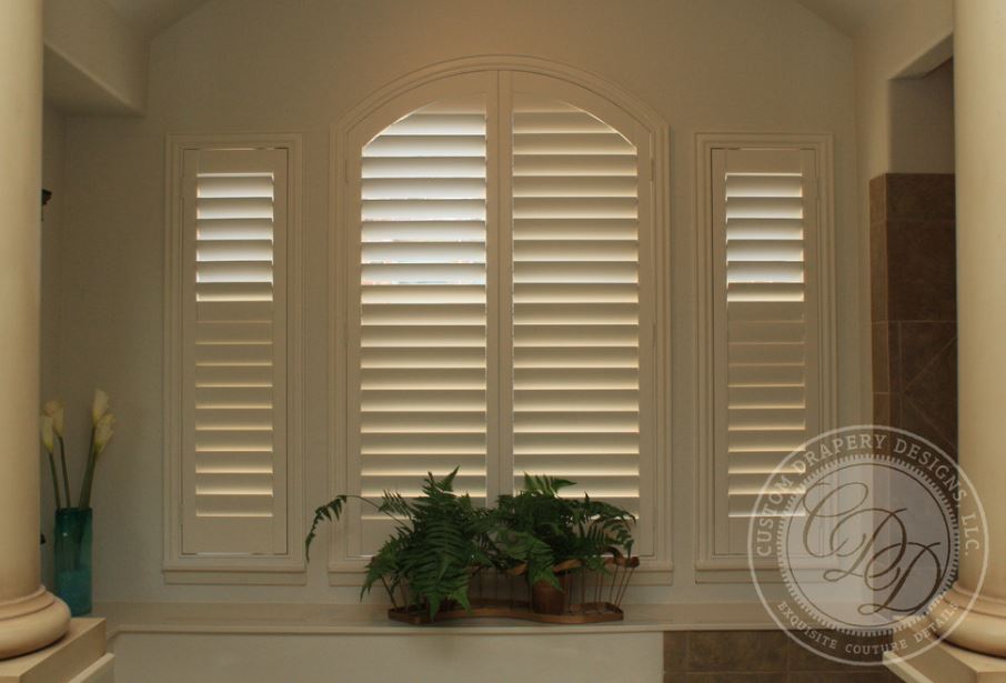 Custom arched window shutters in Highland Park, TX providing energy efficiency
