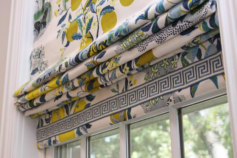 Layered window coverings in University Park, TX living room