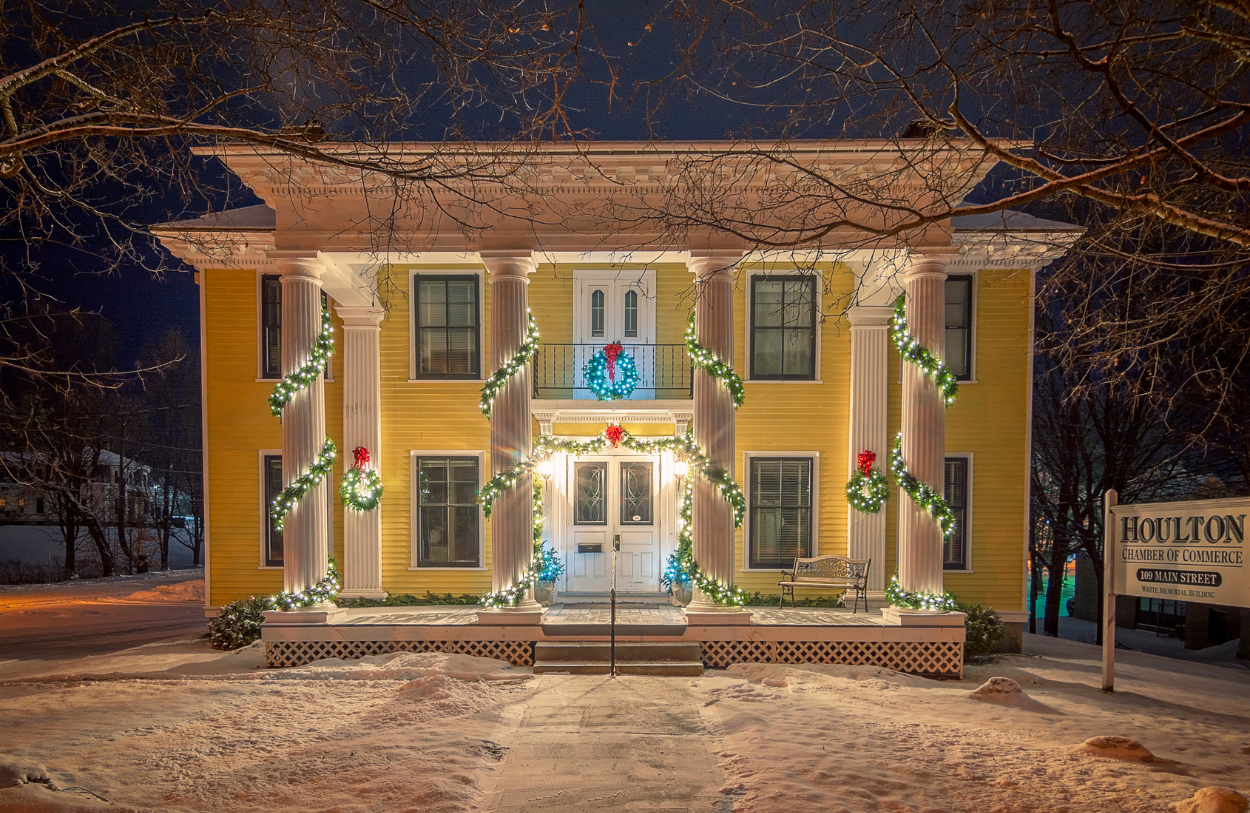 the houlton chamber of commerce building with beautiful white christmas lights and live garlands and wreaths is beautiful on winter day.