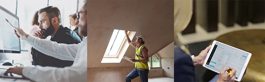 A man with a vest sitting at a computer looking at data.