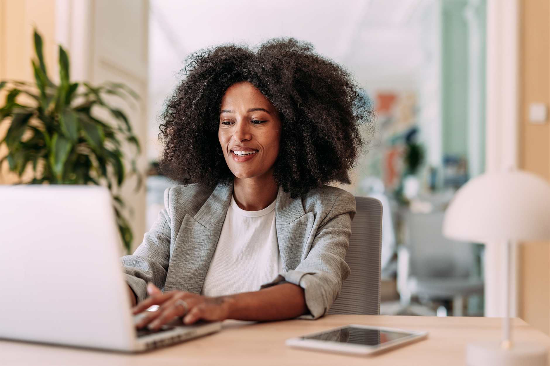 Woman sitting at a desk looking at a laptop screen