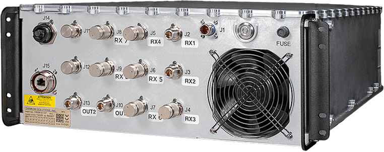 This image shows ThinKom's Digital Beamformer, a metal box with 20 ports, a fan, and a power button. The digital beamformer enables digital arrays via coherent beam combining. 