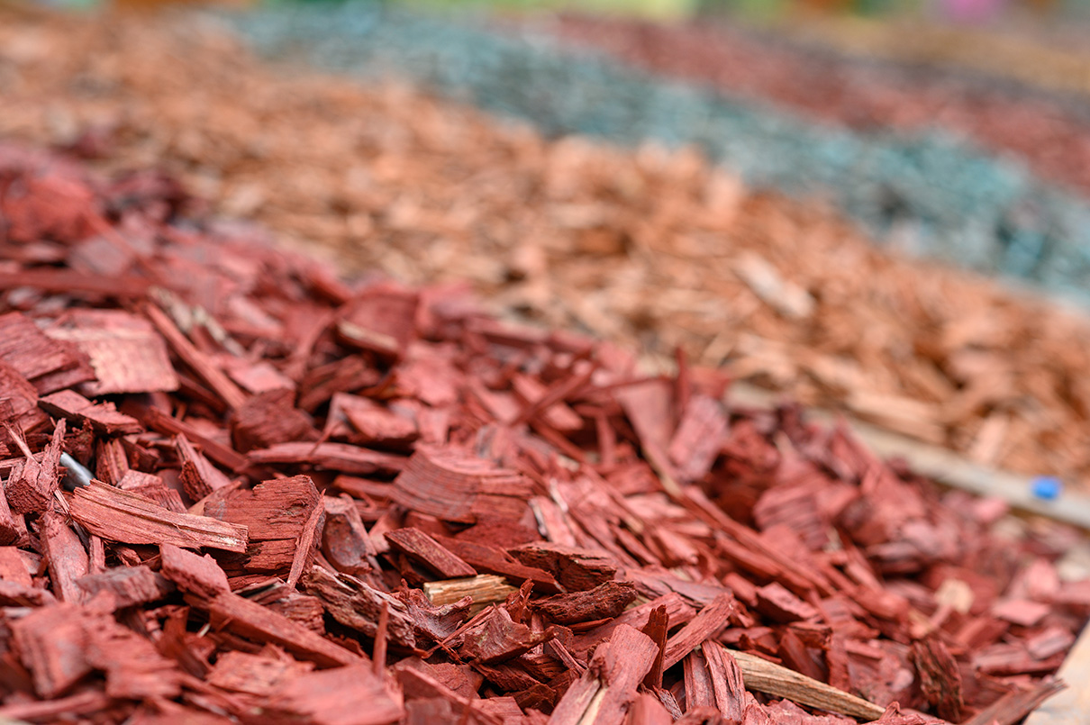 Fresh mulch applied to a garden bed by From The Soil landscaping crew