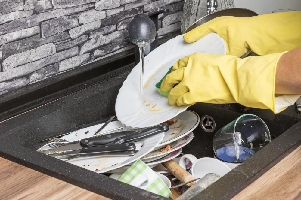 Dirty, greasy dishes in a kitchen sink