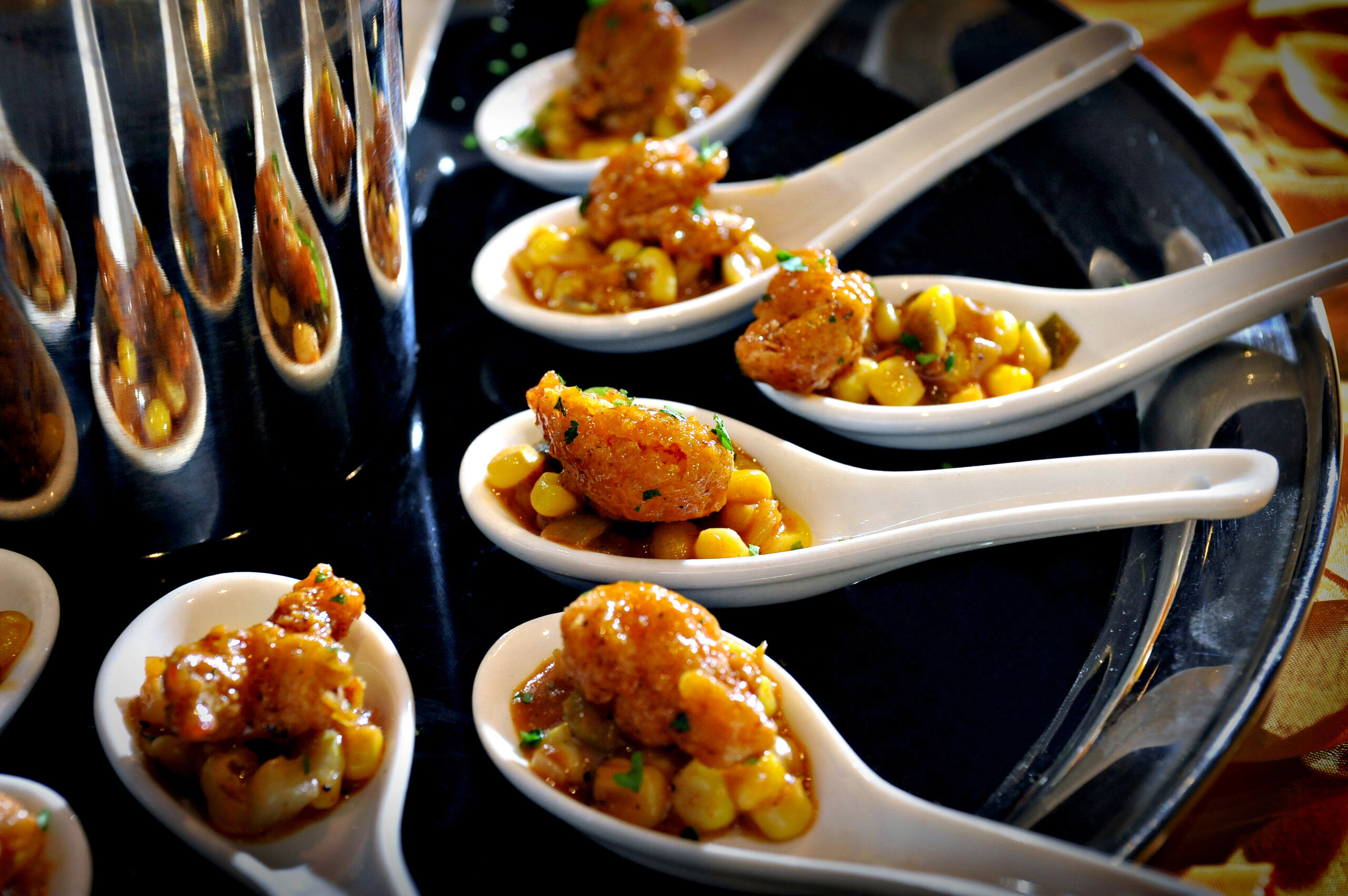 Chef named Brett flambéing food in a pan over a gas stove with flames rising.