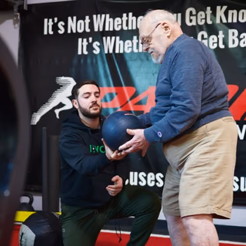 Senior client exercising with a trainer at Evolve Training NJ
