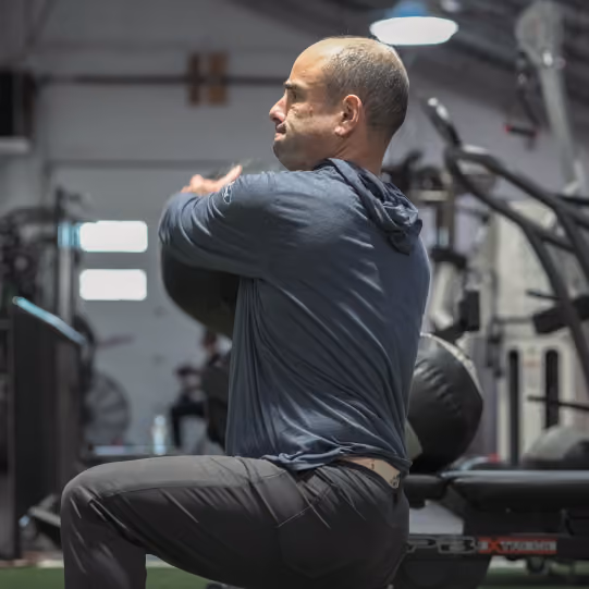 Trainer coaching a client through a strength training exercise at Evolve Training NJ