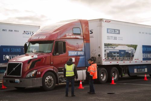 New Sound CDL School class A instructor and student in the paved practice lot.