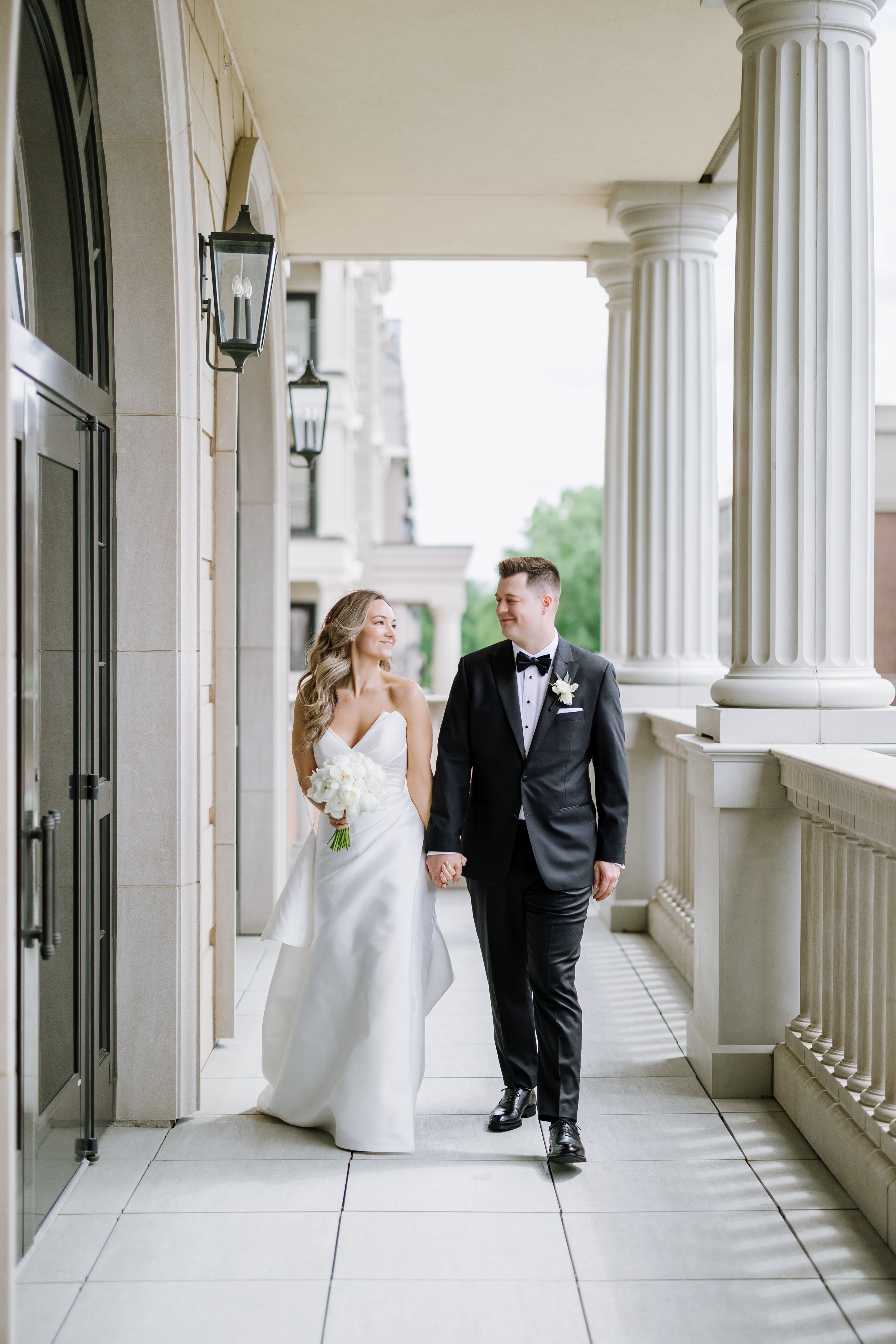 bride and groom walking at hotel carmichael at wedding