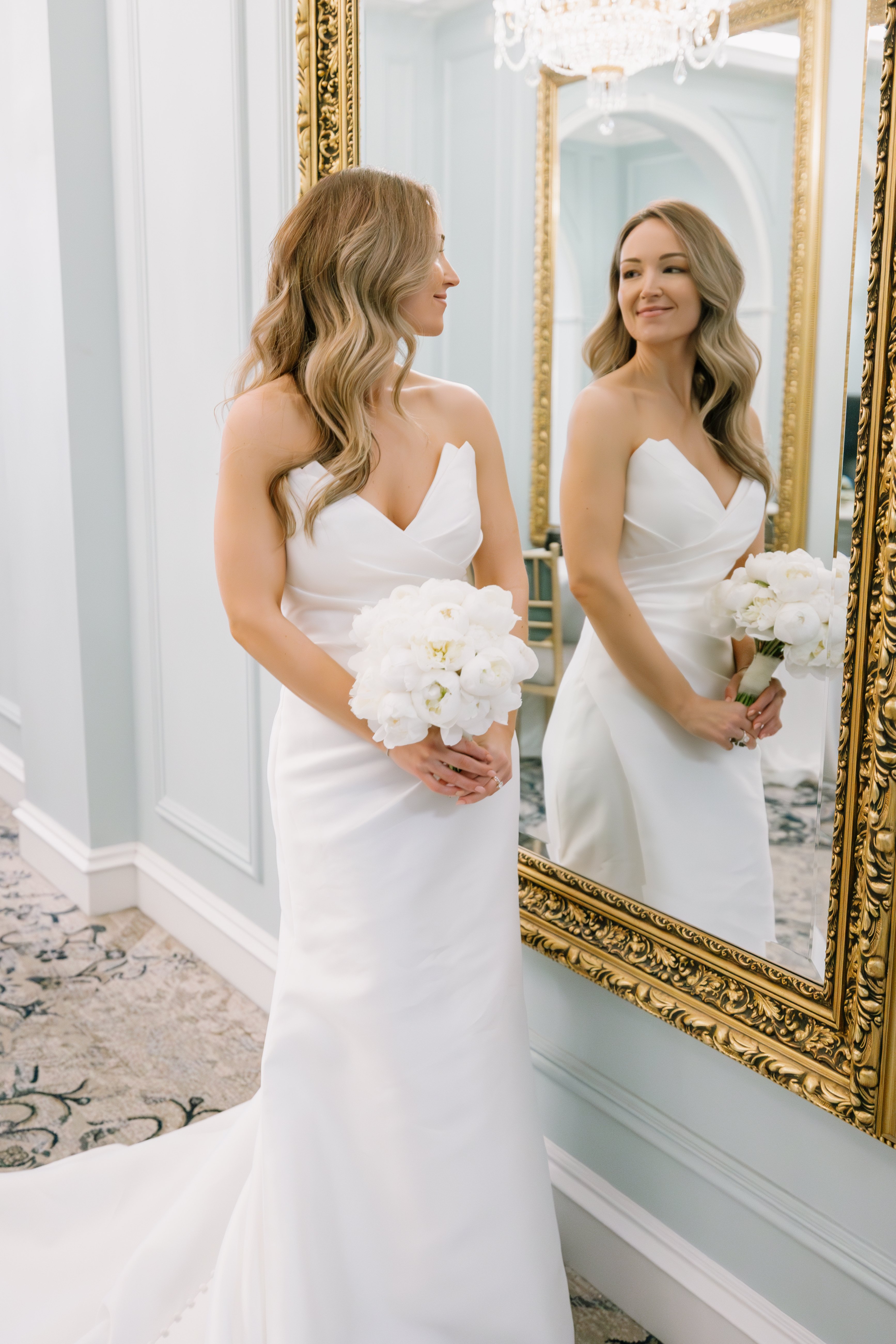 bride looking in mirror at carmichael hotel