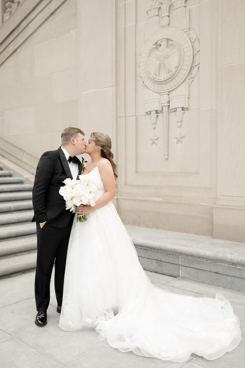 couple stands in front of scottish rite cathedral for wedding