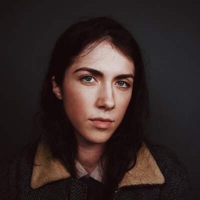portrait photograph of woman in gray and brown coat