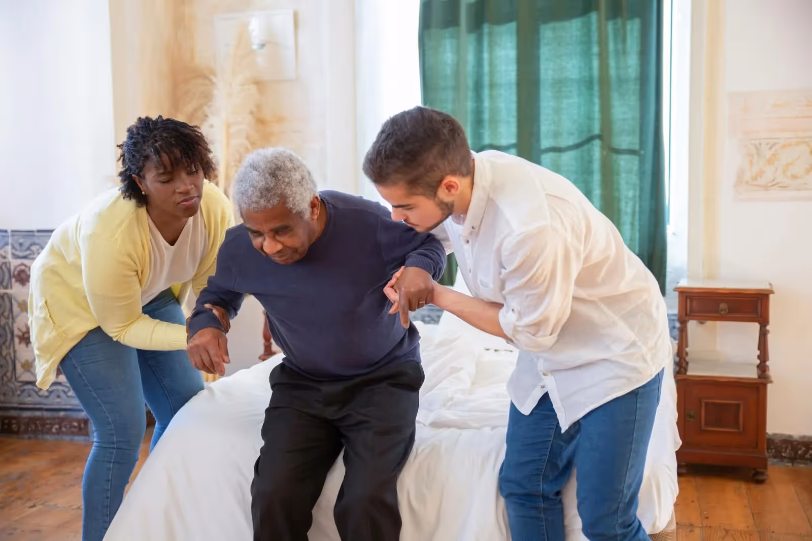 Caregivers assisting aging parent
