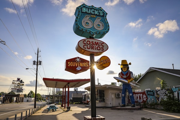 A Route 66 Sign backlit by the Sunset