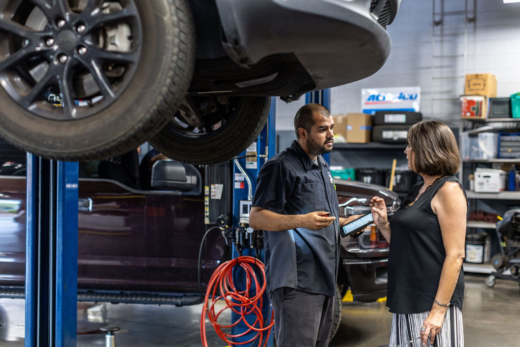 A mom talking with a Car Life Technician about her vehicle