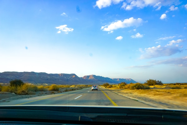 Multiple Car Life Technicians Servicing a Vehicle