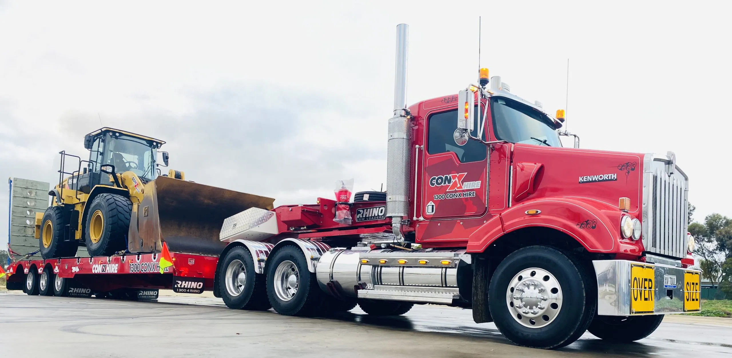 Large piece of earthmoving equipment loaded onto a truck