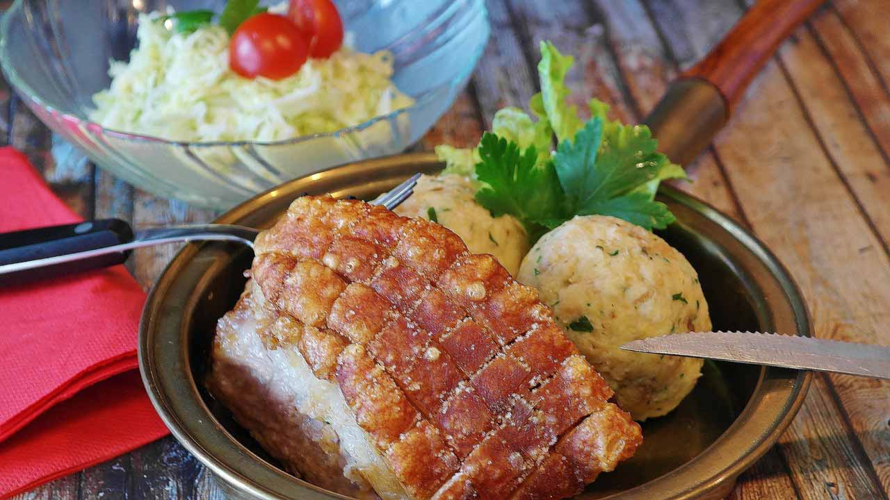 Roast dinner on a plate with salad bowl behind