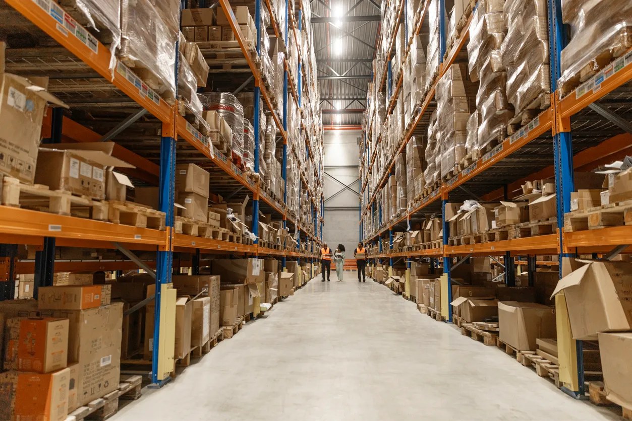 High-bay warehouse with long shelving rows