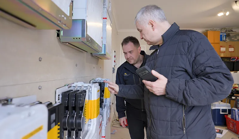 Essential Solar's Sam speaking with home owner during installation at the battery location