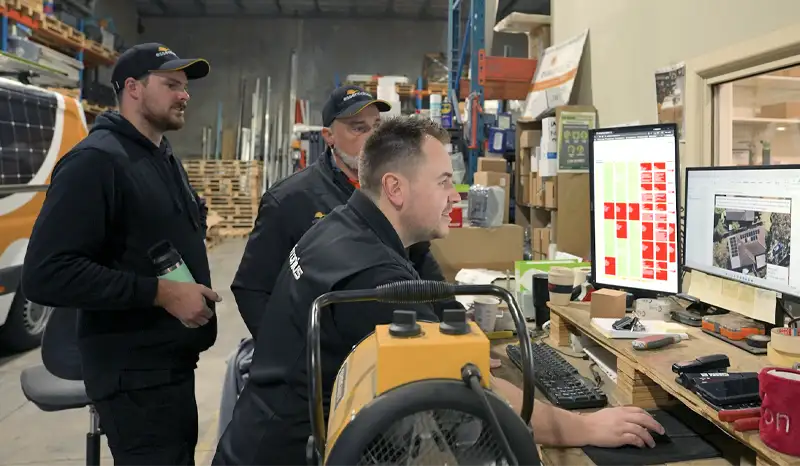 Essential Solar team working in the warehouse on the computer
