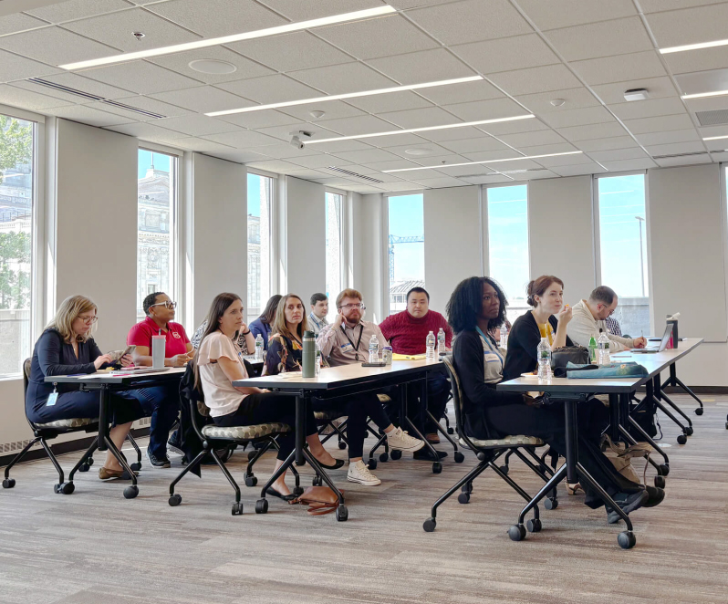 Conference room filled with people watching a presentation