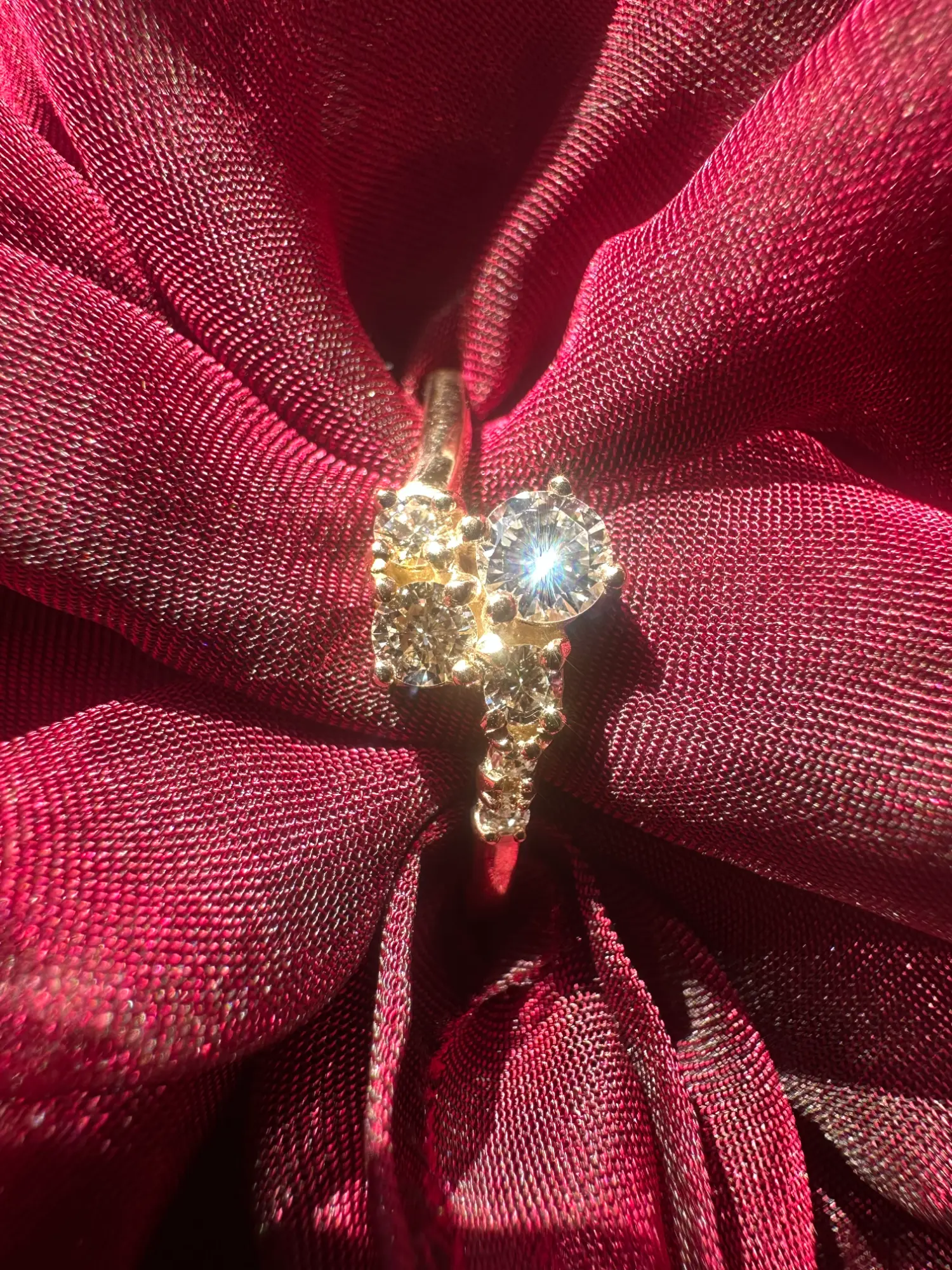 A close-up of two rings placed on a collection of green beads, highlighting their beauty and craftsmanship against the colorful backdrop.