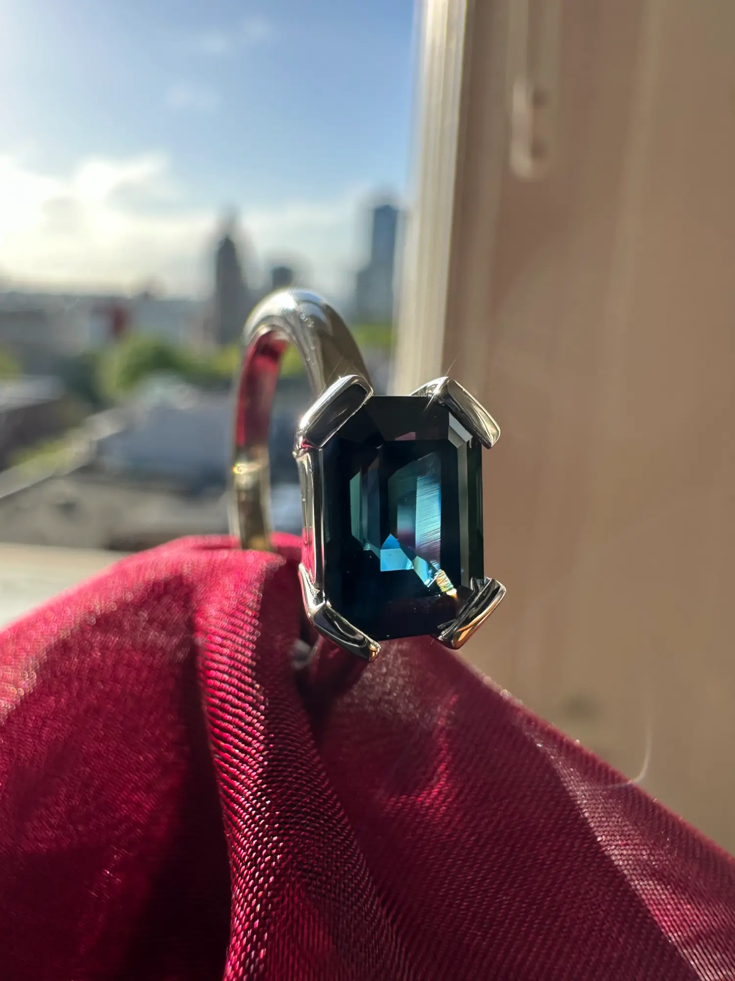 A stunning diamond ring resting on a lush red rose, representing beauty and romance.